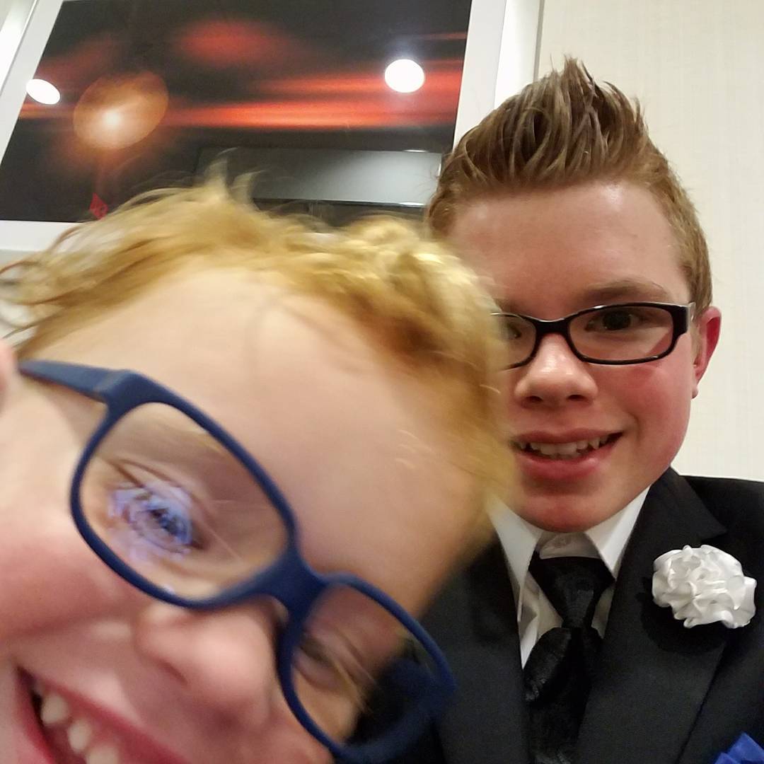 A teenage Ryleigh Newman in a suit at a Muscular Dystrophy Association event as Florida State Ambassador.
